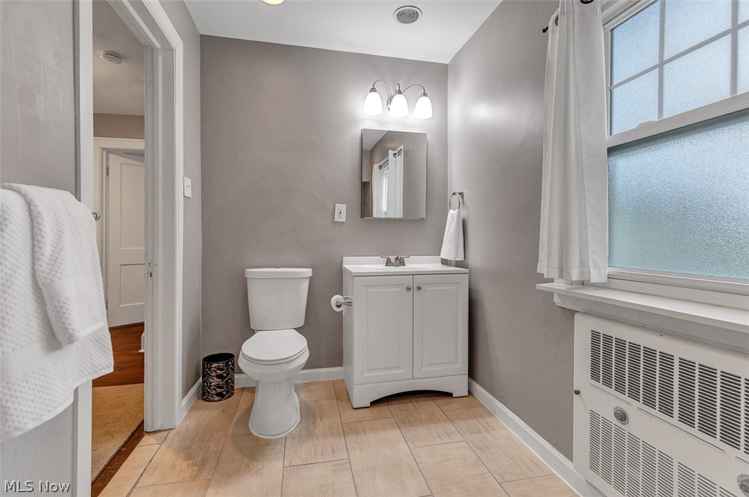 2972 Yorkshire Road Cleveland Heights, OH 44118 - Photo 32 of 44 Bathroom featuring a single vanity with storage, a white toilet, and neutral wall paint