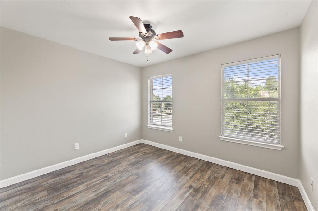 2700 Breezy Point Cove Round Rock, TX 78665 - Photo 12 of 26 a view of an empty room with wooden floor and a window
