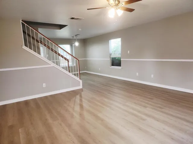 a view of an entryway with wooden floor