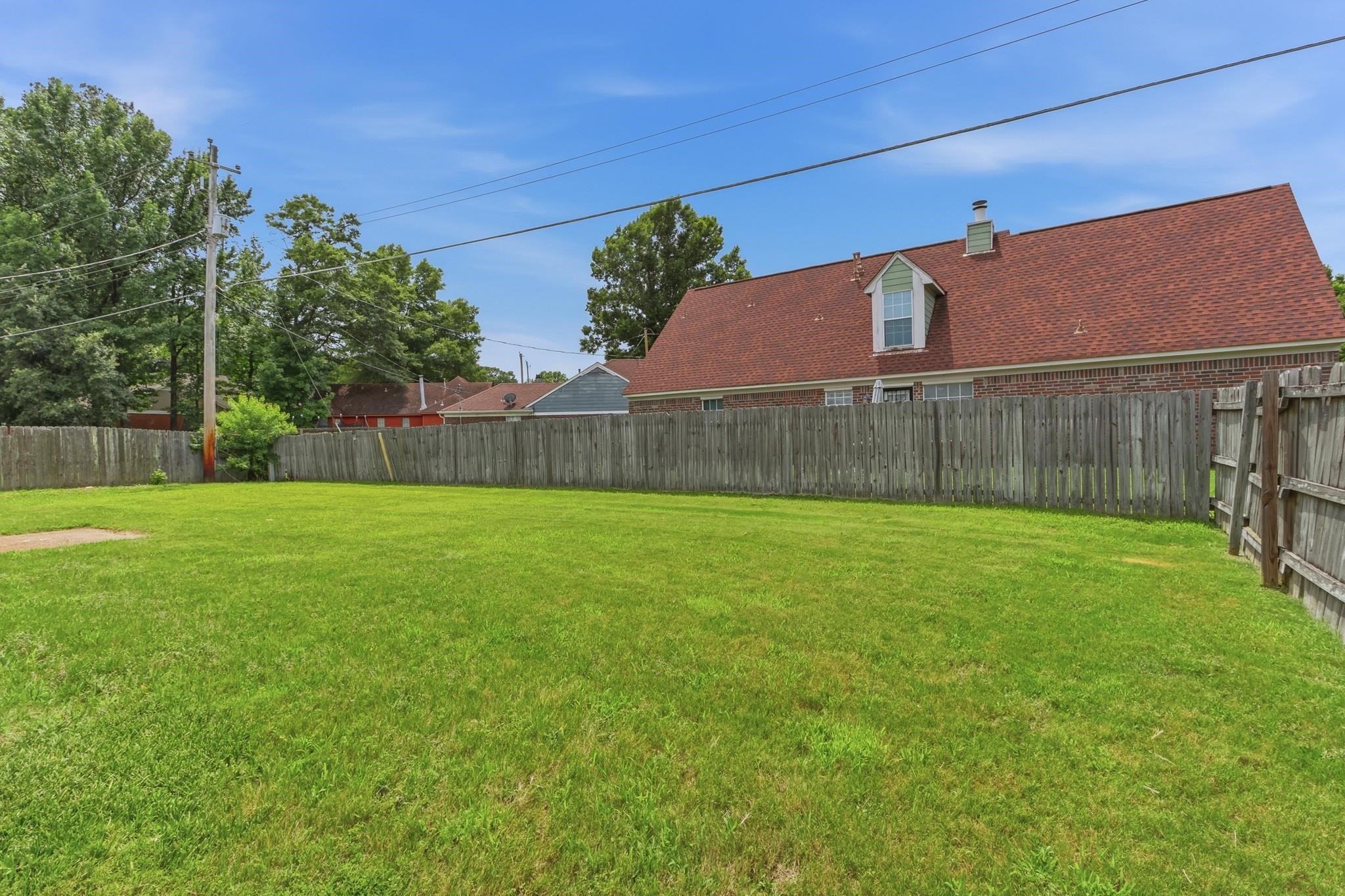 4101 Long Creek Road Memphis, TN 38125 - Photo 31 of 36 Expansive green lawn surrounded by a wooden privacy fence