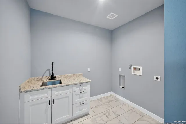 a room with a sink and cabinets