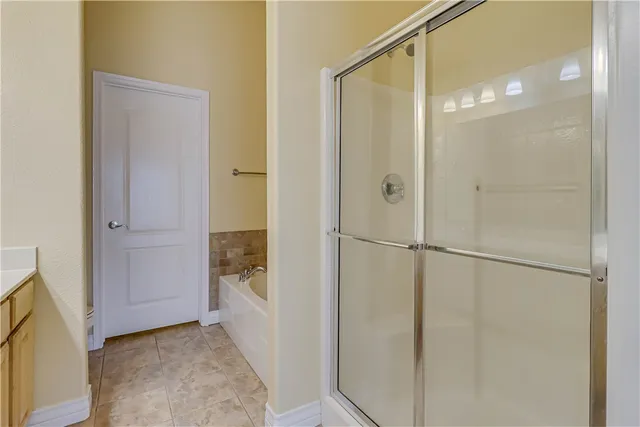 a bathroom with a glass shower door