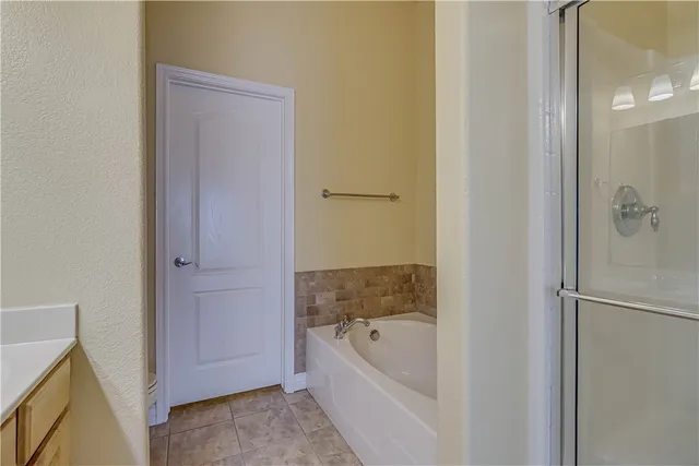 a bathroom with a bathtub and shower