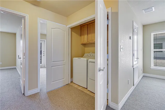 an entryway with a livingroom and a bathroom