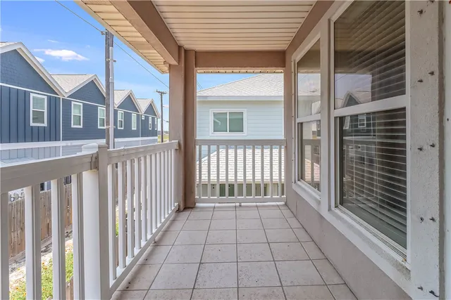a view of a brick house with a porch