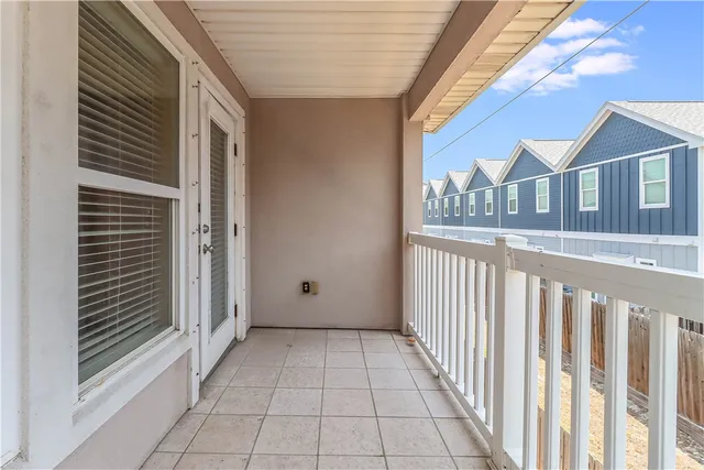 a view of a porch with a door and a window