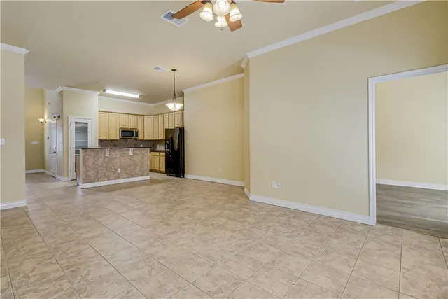 a view of a kitchen with refrigerator and a ceiling fan