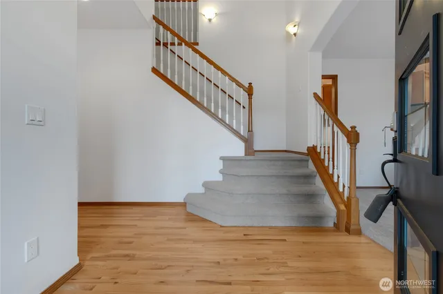a view of entryway and hall with wooden floor