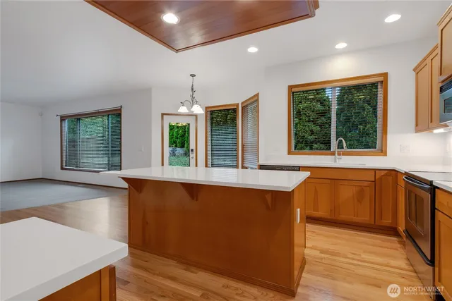 a view of a kitchen with a sink and large window