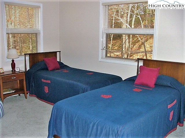 502 St Andrews Road Beech Mountain, NC 28604 - Photo 9 of 34 a bedroom with a bed and window