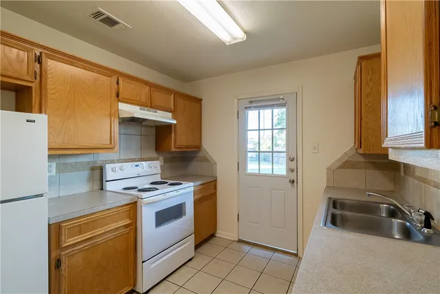a kitchen that has a sink and a stove
