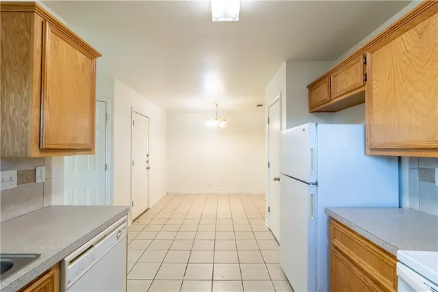 a kitchen with a sink and a refrigerator