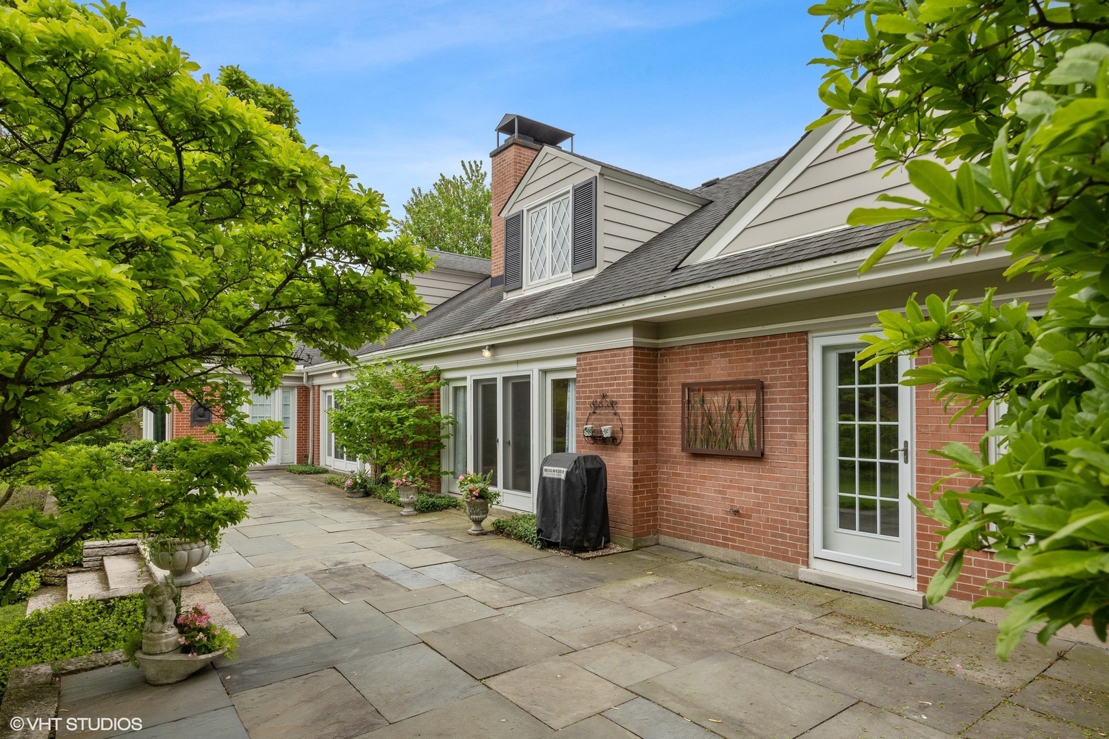 17 Meadowview Road Northfield, IL 60093 - Photo 44 of 50 a view of a house with brick walls plants and large tree