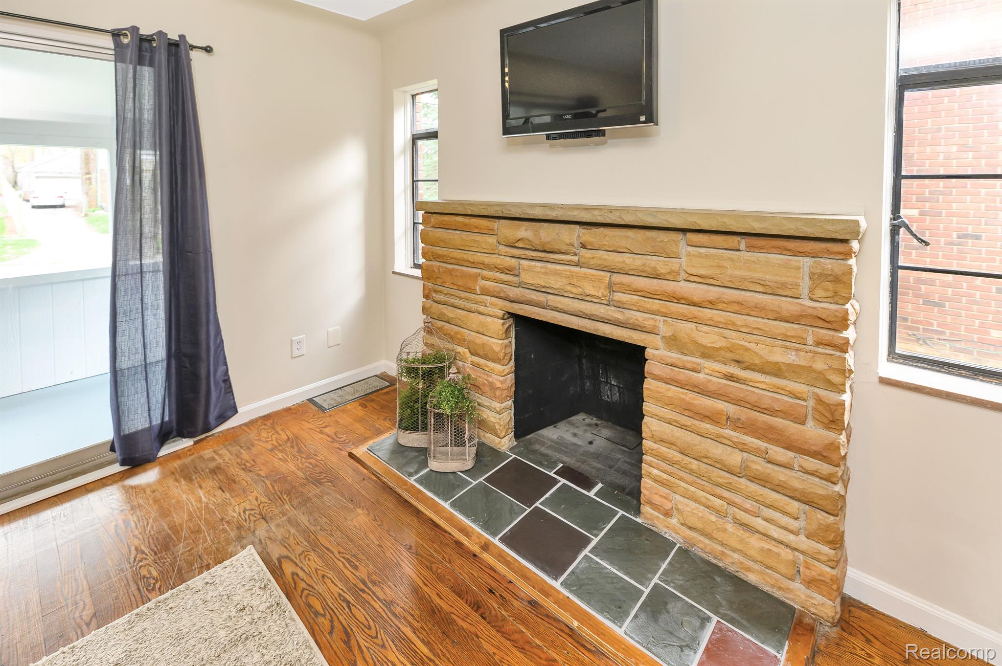 203 Ogemaw Road Pontiac, MI 48341 - Photo 6 of 24 Natural Fireplace with Slate and Brick Detailing.
