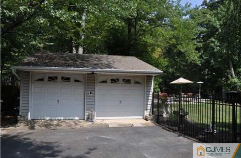 68 Richard Road Edison, NJ 08820 - Photo 11 of 25 a view of a wooden house with a yard and potted plants