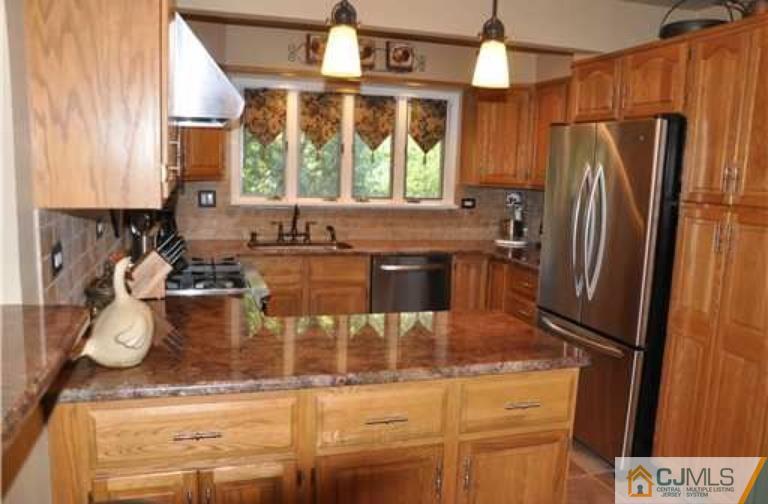 68 Richard Road Edison, NJ 08820 - Photo 14 of 25 a kitchen with stainless steel appliances granite countertop a sink a stove and a refrigerator