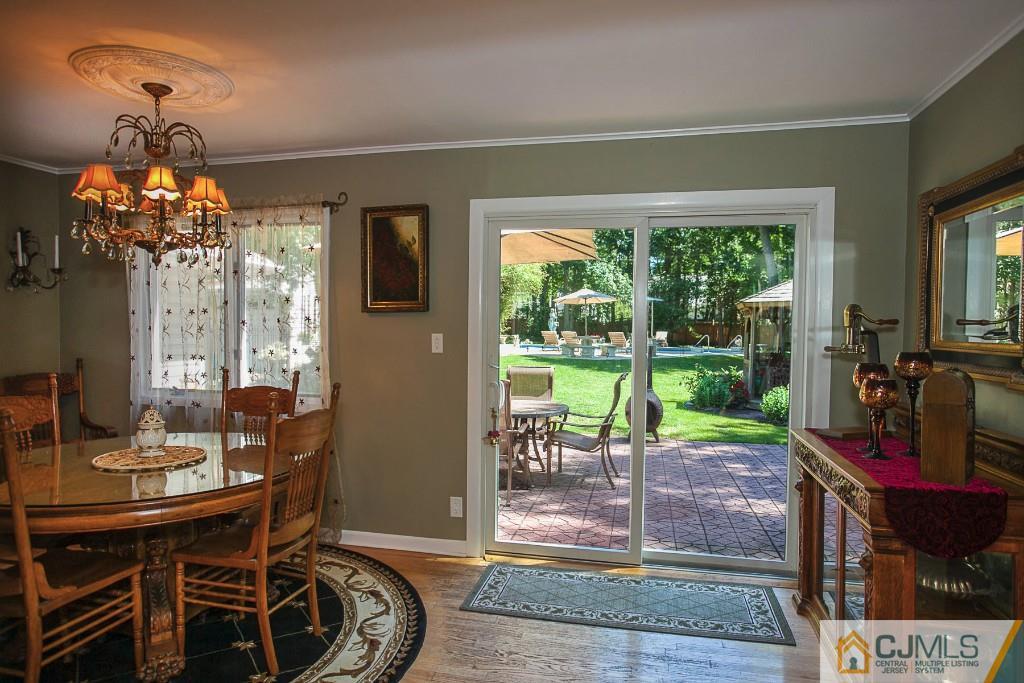 68 Richard Road Edison, NJ 08820 - Photo 17 of 25 a view of a dining room with furniture wooden floor and chandelier