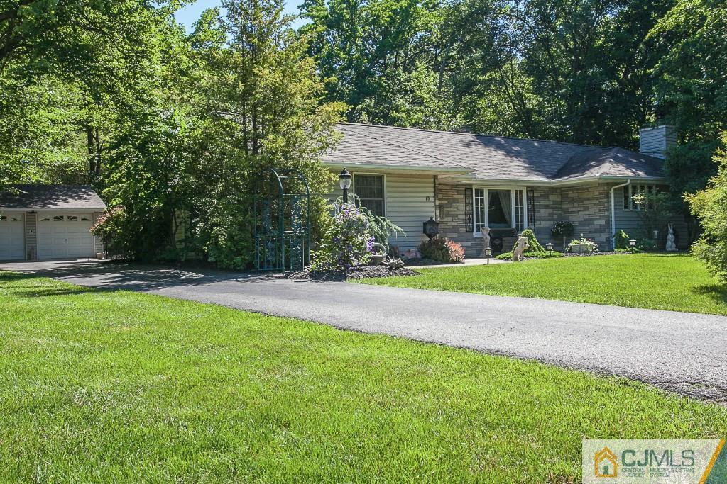 68 Richard Road Edison, NJ 08820 - Photo 3 of 25 a front view of a house with garden and a tree