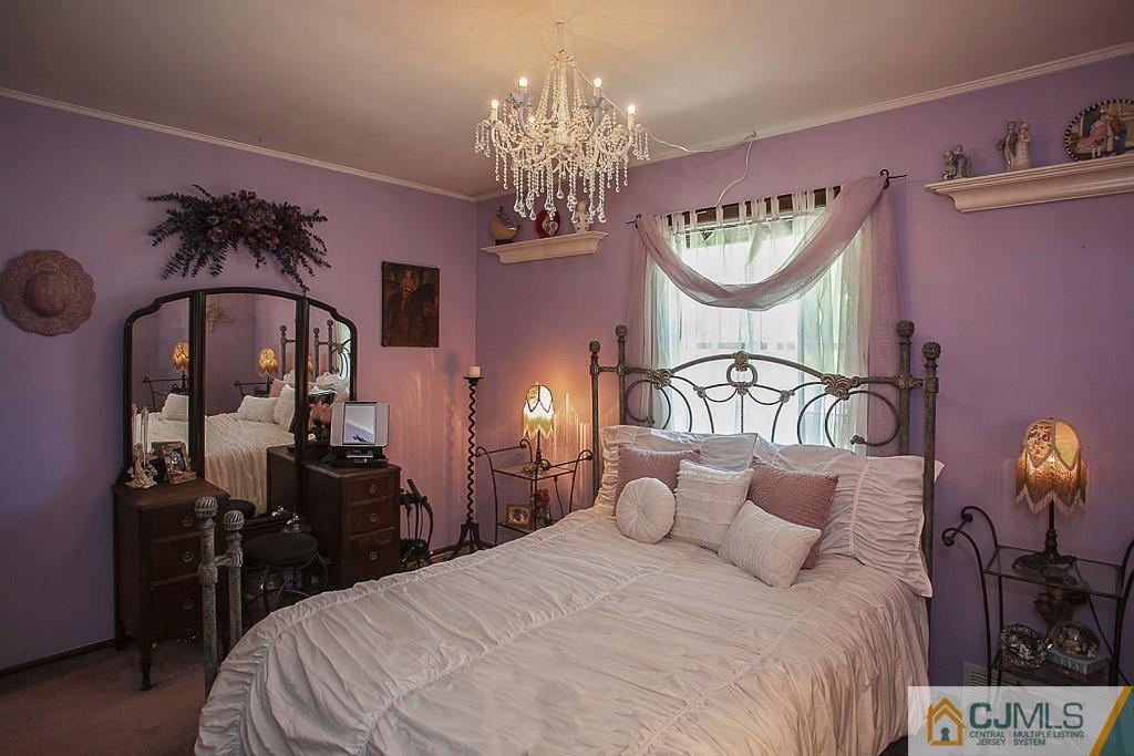 68 Richard Road Edison, NJ 08820 - Photo 21 of 25 a bedroom with a bed a mirror and dresser