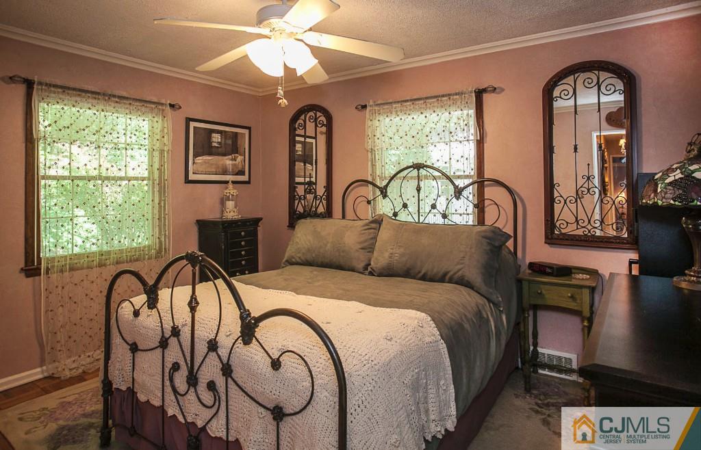 68 Richard Road Edison, NJ 08820 - Photo 23 of 25 a bedroom with a bed and dresser with wooden floor