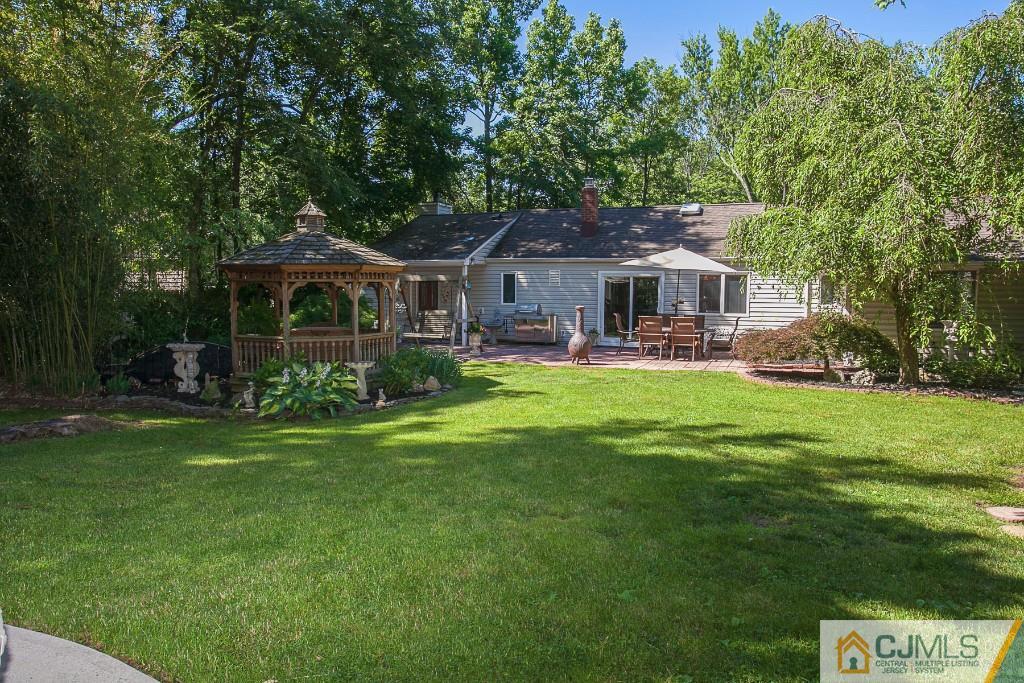 68 Richard Road Edison, NJ 08820 - Photo 5 of 25 a front view of a house with a garden and trees