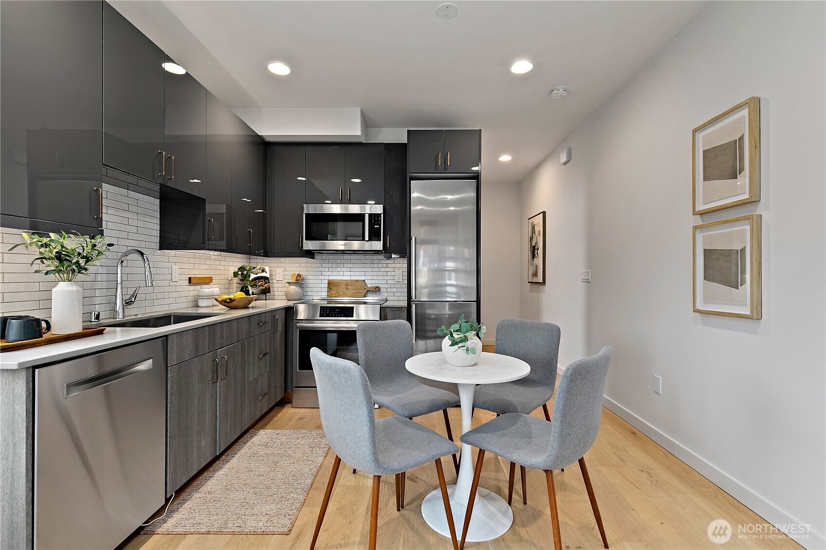 4100 37th Avenue South Seattle, WA 98118 - Photo 9 of 19 a kitchen with a dining table chairs and microwave