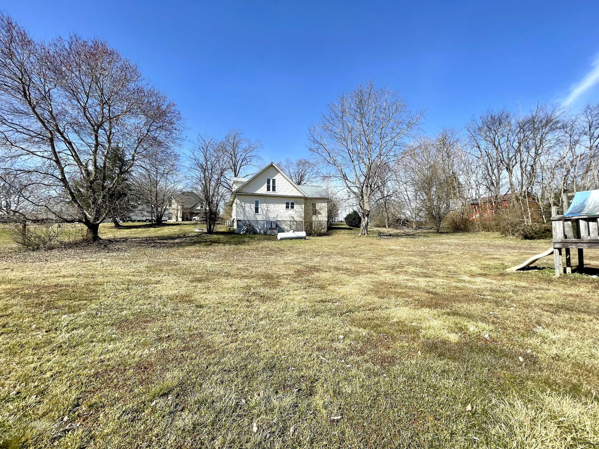 313 Smith Road Cornersville, TN 37047 - Photo 10 of 27 a view of a yard with a house in the background