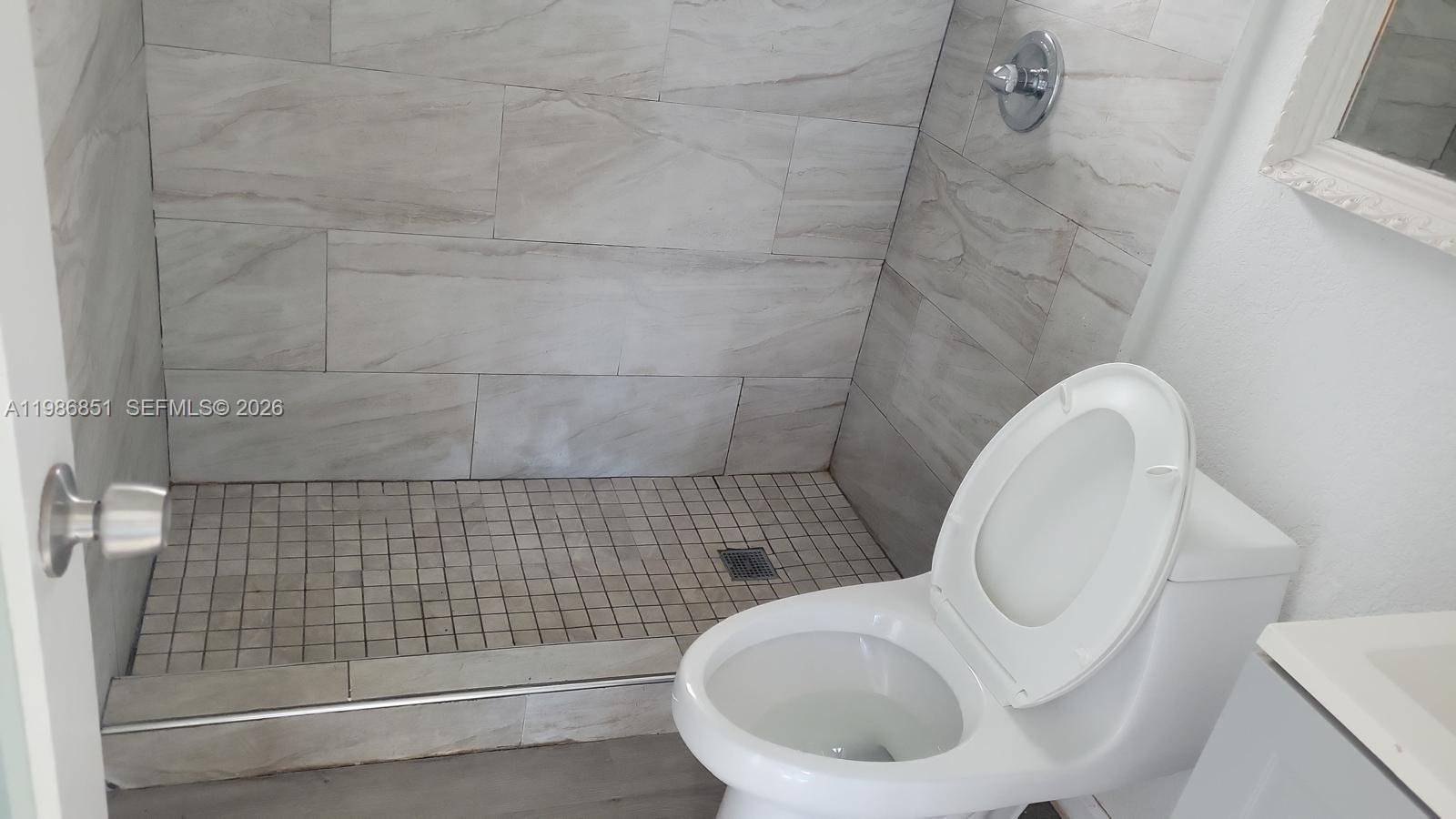 1212 Southwest 7th Street, Unit 1 Miami, FL 33130 - Photo 2 of 6 a bathroom with a toilet and a shower