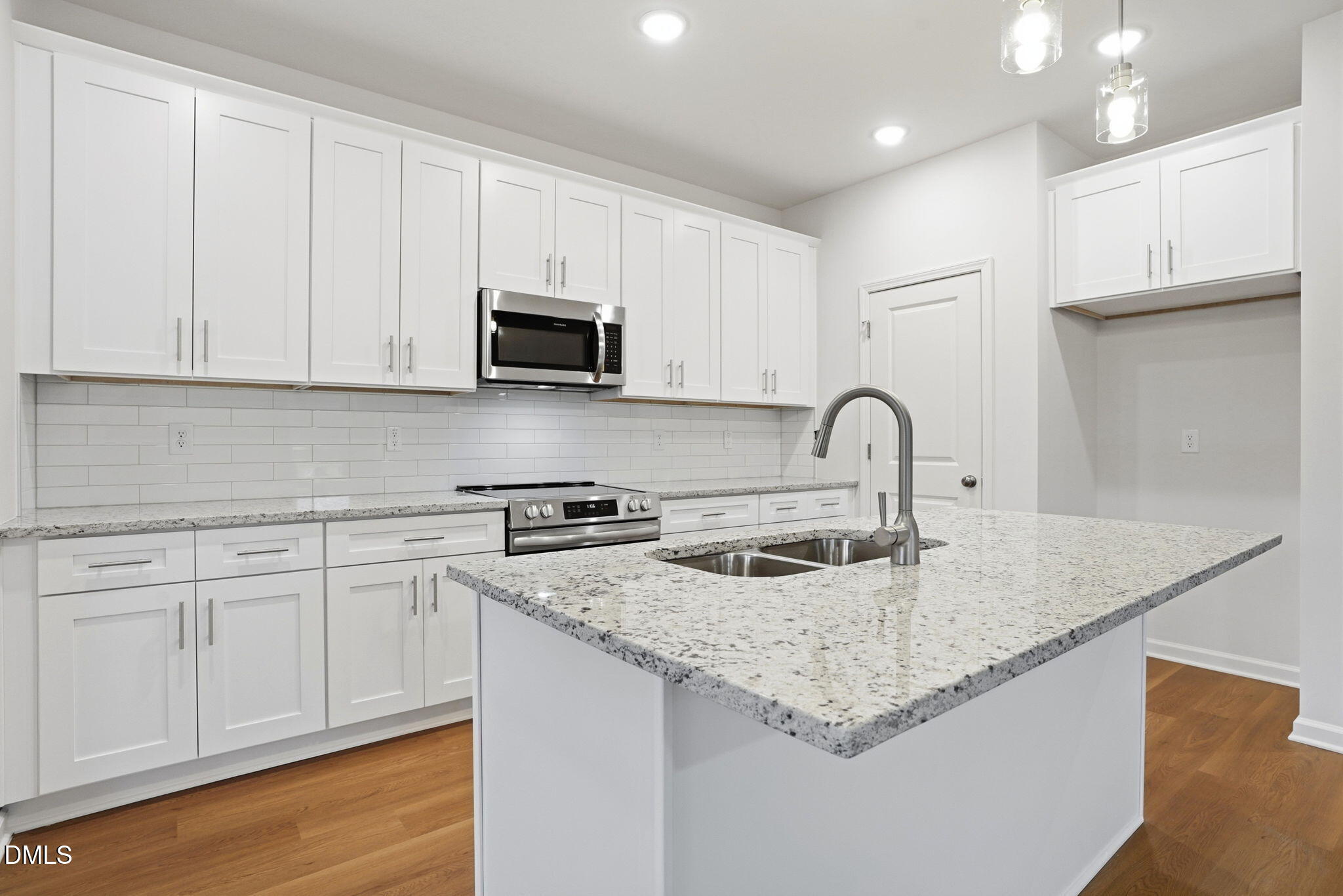 9019 Phoenix Court Spring Hope, NC 27882 - Photo 13 of 34 a kitchen with granite countertop white cabinets and sink
