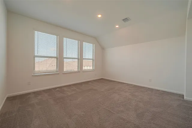 a view of an empty room and a window