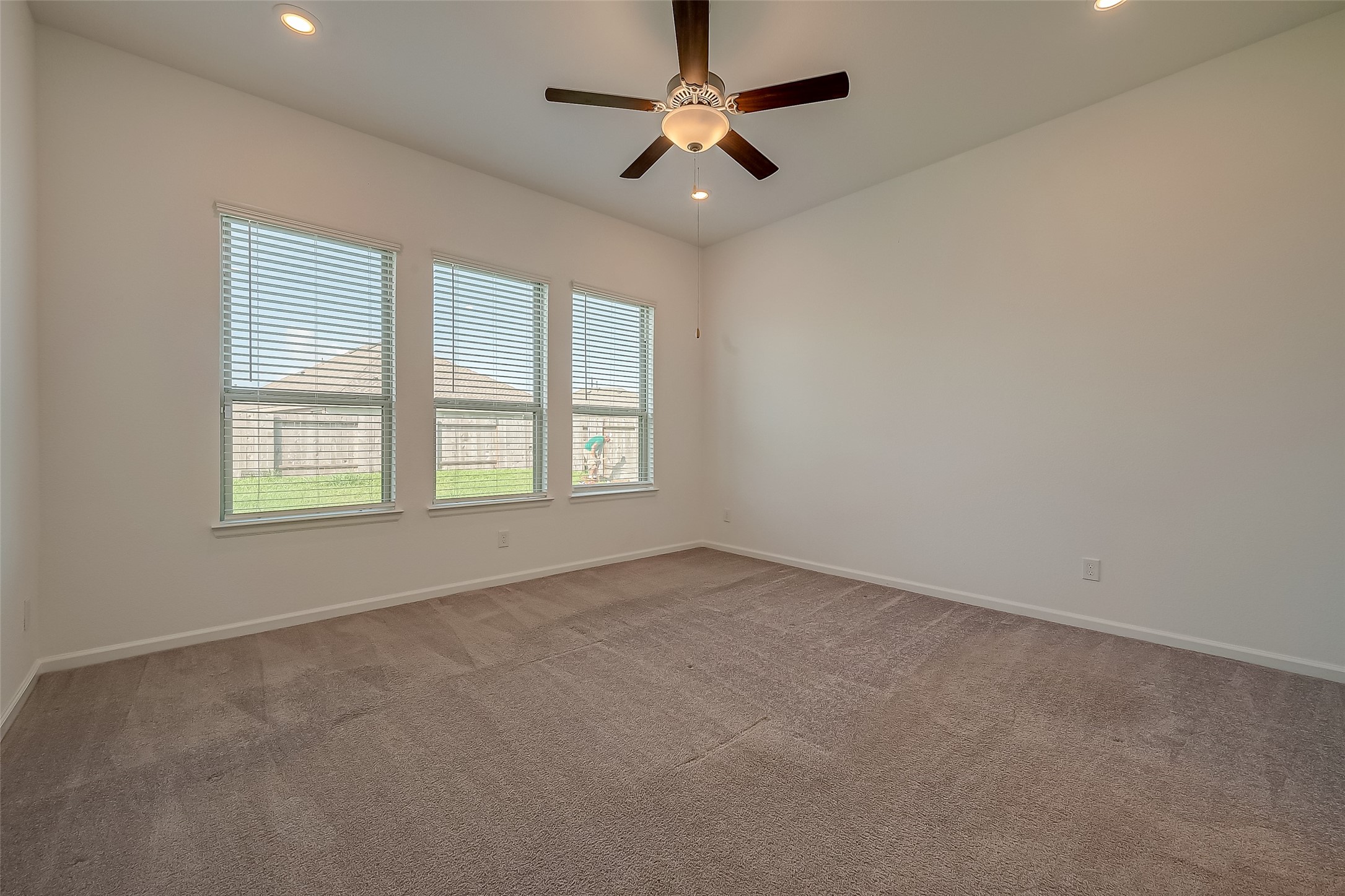 5010 Slate Prt Court Rosenberg, TX 77469 - Photo 26 of 39 an empty room with a window and a fan
