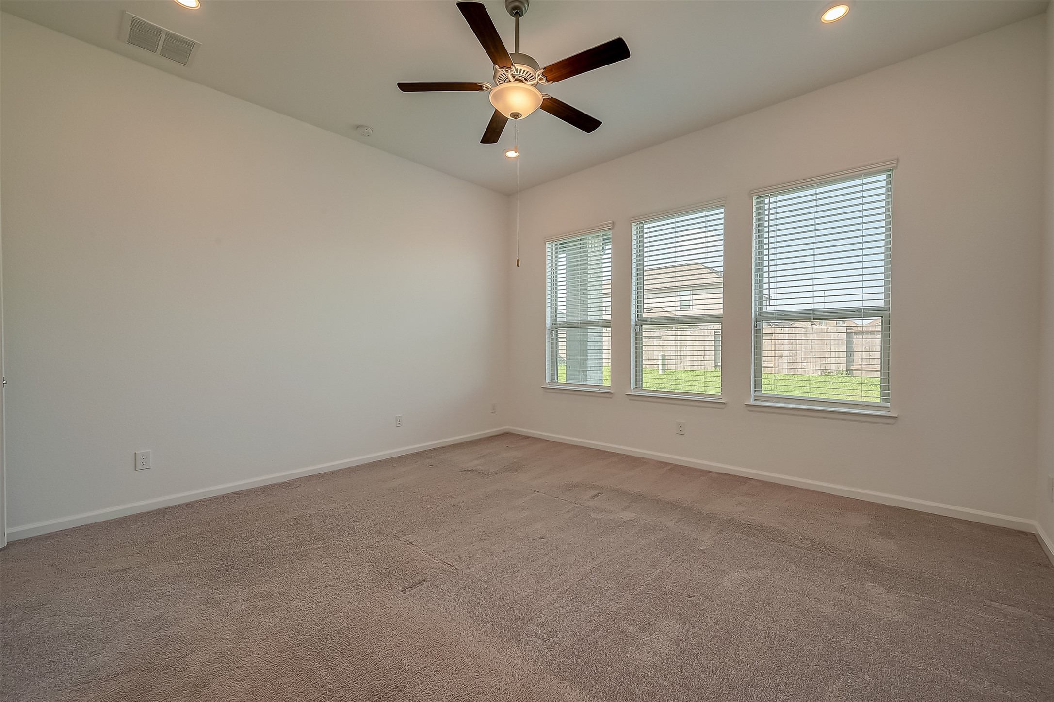 5010 Slate Prt Court Rosenberg, TX 77469 - Photo 28 of 39 an empty room with a window and a fan
