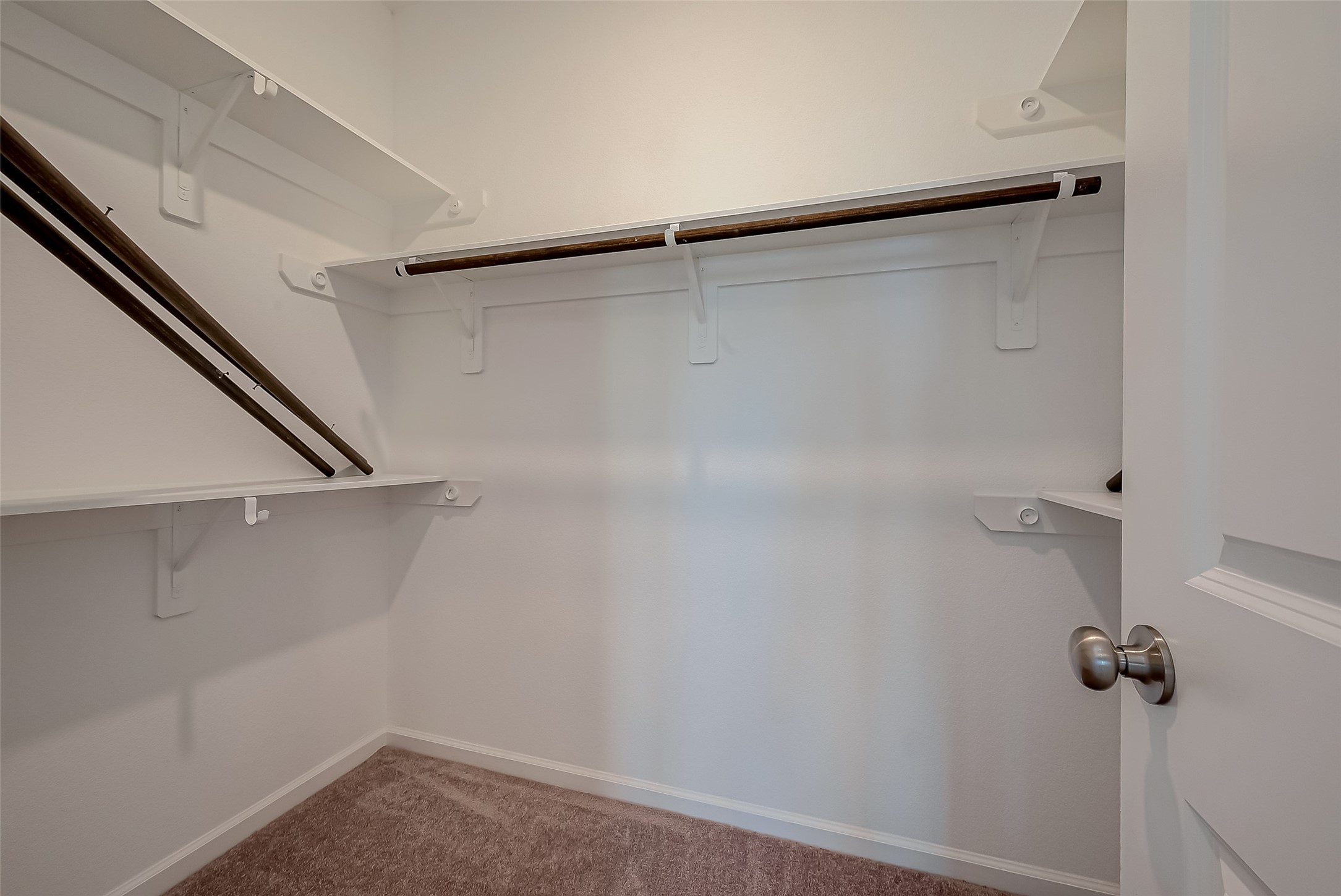 5010 Slate Prt Court Rosenberg, TX 77469 - Photo 36 of 39 Walk-in closet with multiple shelves and hanging rods, offering ample storage space.