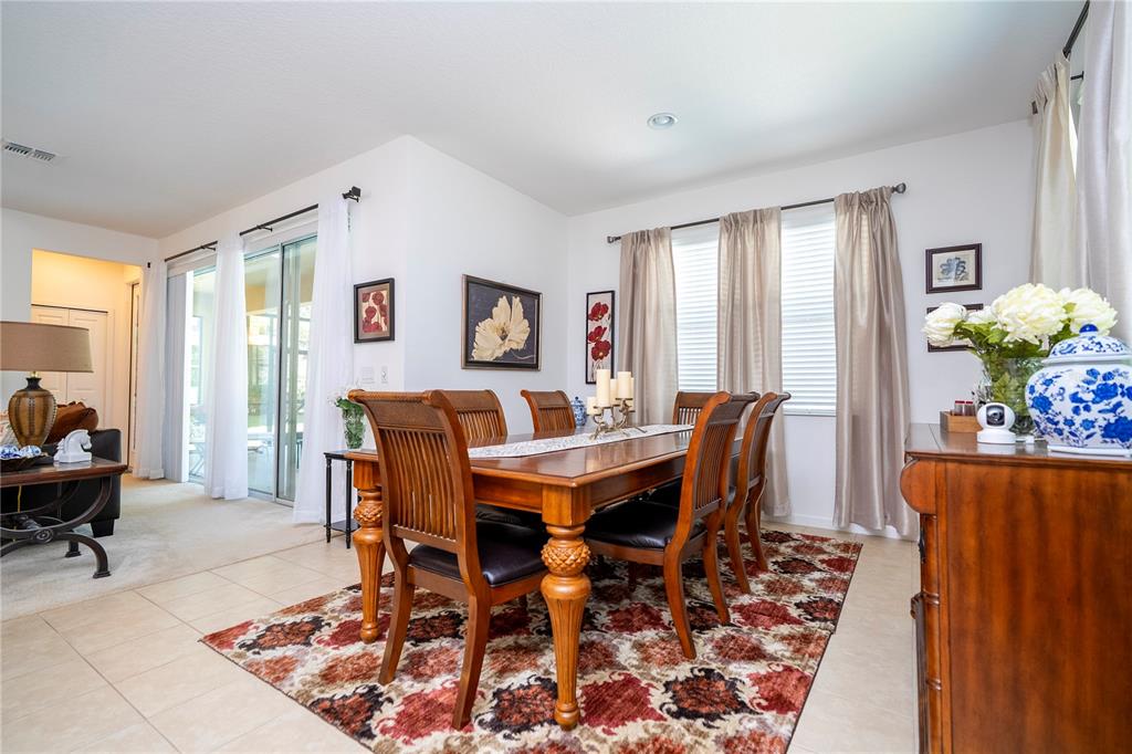 4561 Cabello Loop Kissimmee, FL 34746 - Photo 37 of 100 a view of a dining room with furniture window and wooden floor