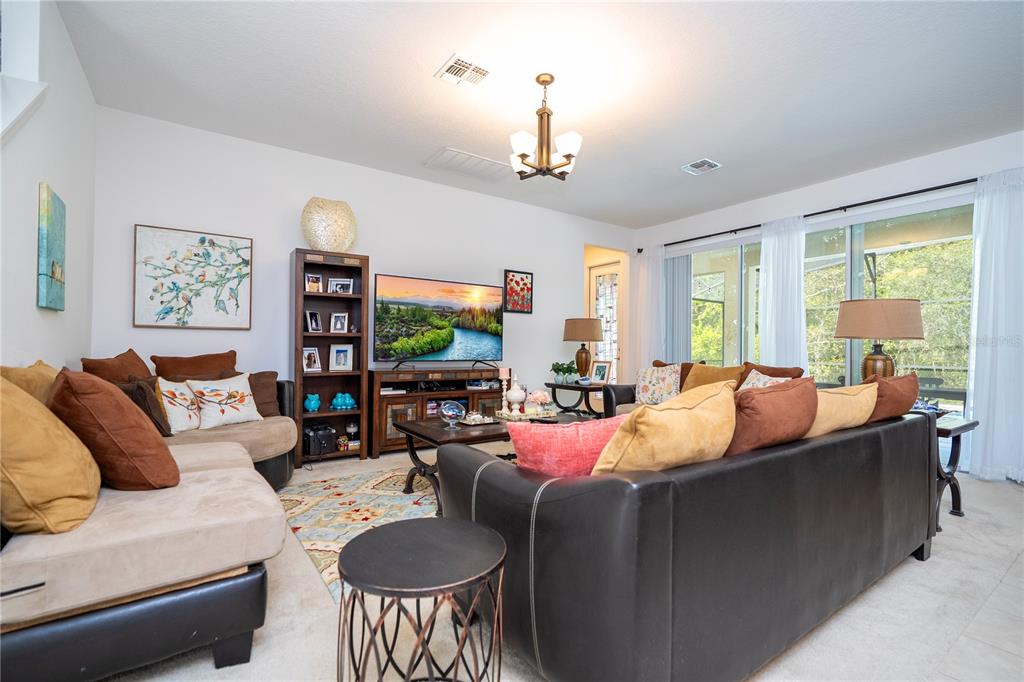 4561 Cabello Loop Kissimmee, FL 34746 - Photo 41 of 100 a living room with furniture flat screen tv and a large window
