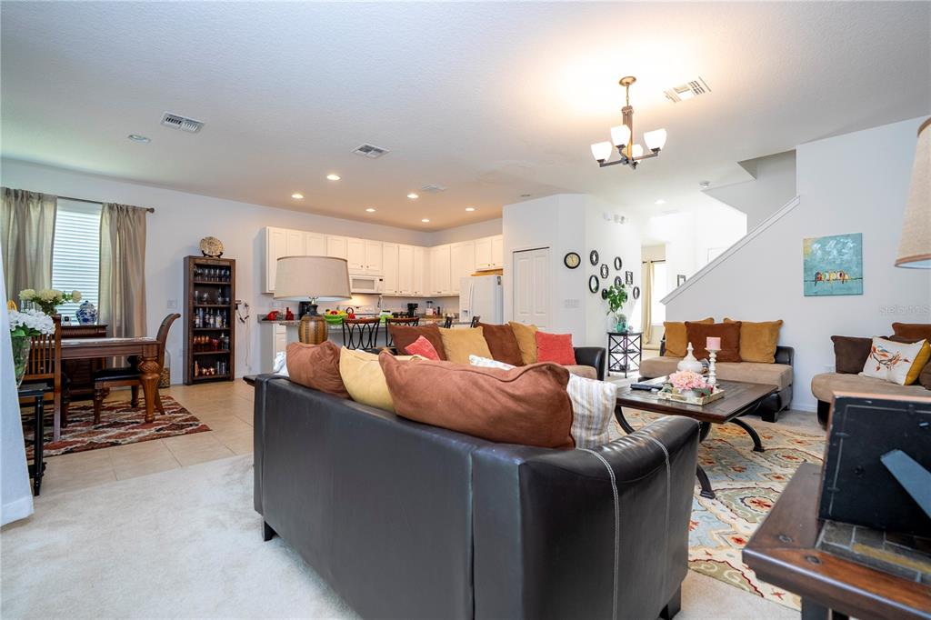 4561 Cabello Loop Kissimmee, FL 34746 - Photo 43 of 100 a living room with furniture kitchen view and a chandelier