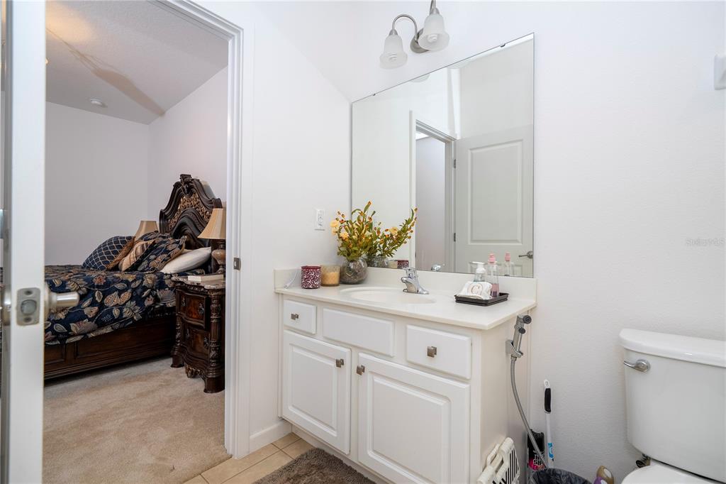4561 Cabello Loop Kissimmee, FL 34746 - Photo 45 of 100 a bathroom with a sink a toilet and mirror