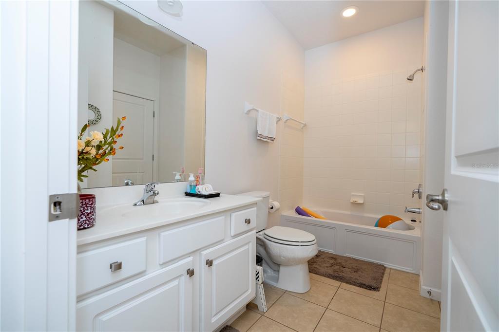4561 Cabello Loop Kissimmee, FL 34746 - Photo 46 of 100 a bathroom with a sink toilet and a mirror