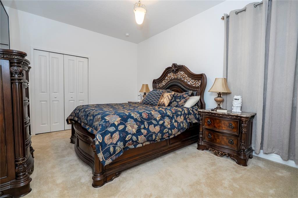 4561 Cabello Loop Kissimmee, FL 34746 - Photo 47 of 100 a bedroom with a bed and a dresser