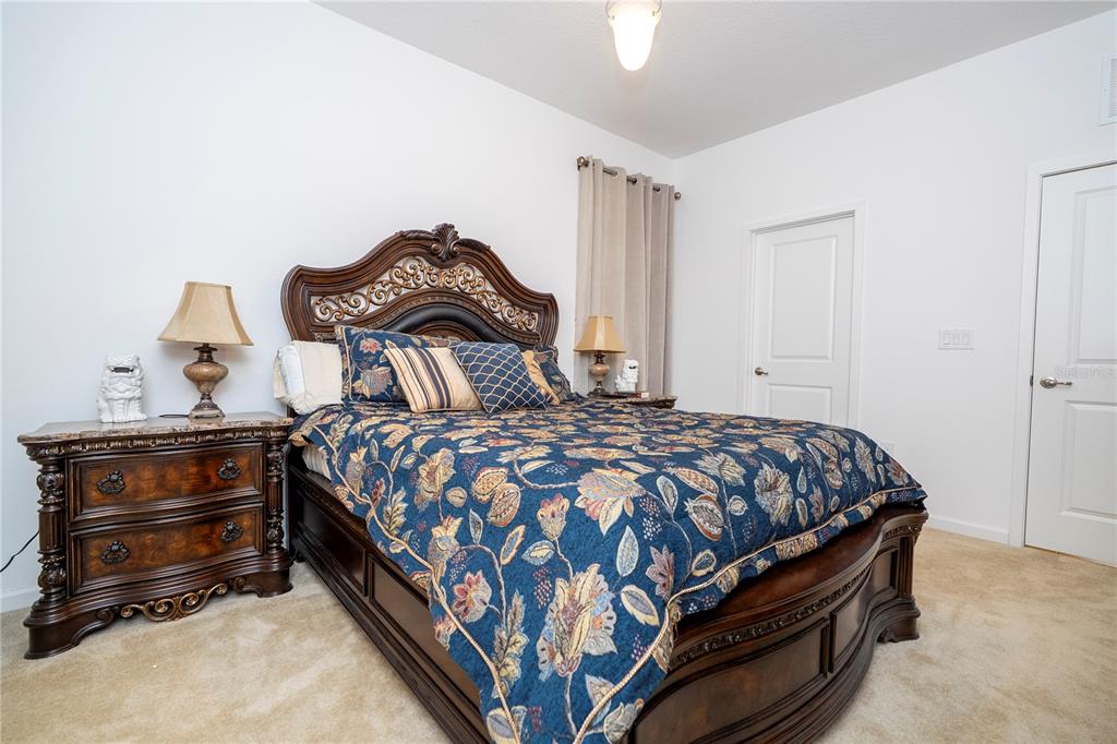 4561 Cabello Loop Kissimmee, FL 34746 - Photo 48 of 100 a bedroom with a bed and a dresser