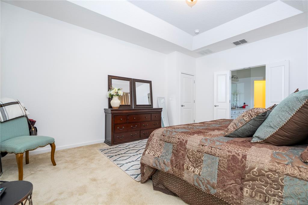 4561 Cabello Loop Kissimmee, FL 34746 - Photo 66 of 100 a bedroom with a bed and wooden floor