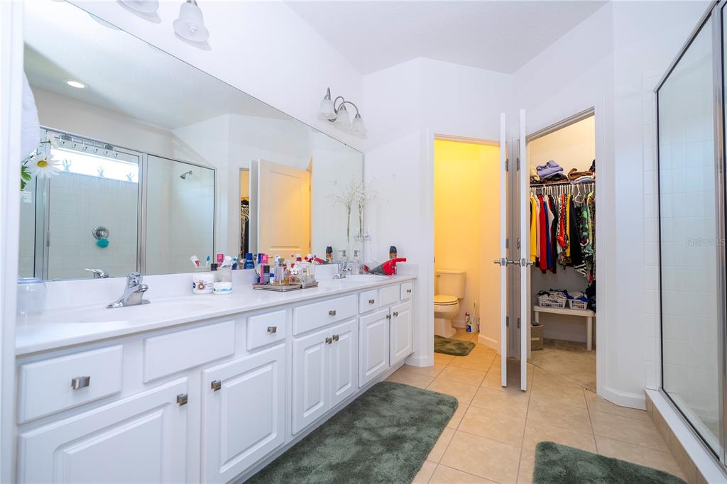 4561 Cabello Loop Kissimmee, FL 34746 - Photo 69 of 100 a spacious bathroom with a double vanity sink and a mirror