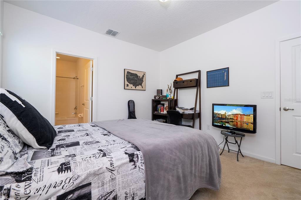 4561 Cabello Loop Kissimmee, FL 34746 - Photo 72 of 100 a bedroom with a bed and a flat screen tv