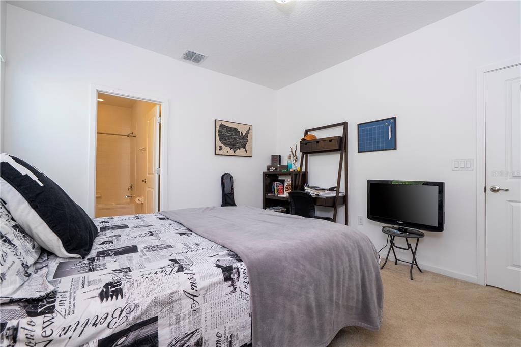4561 Cabello Loop Kissimmee, FL 34746 - Photo 73 of 100 a bedroom with a bed and a flat screen tv