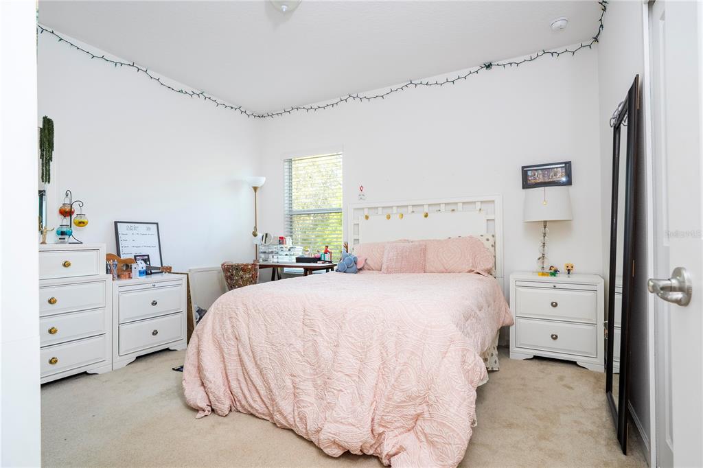 4561 Cabello Loop Kissimmee, FL 34746 - Photo 76 of 100 a bedroom with a bed and a window