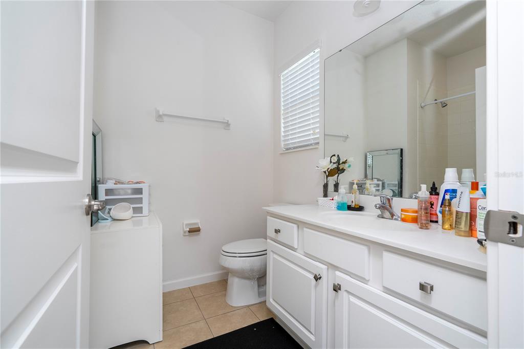 4561 Cabello Loop Kissimmee, FL 34746 - Photo 78 of 100 a bathroom with a sink a toilet and a mirror