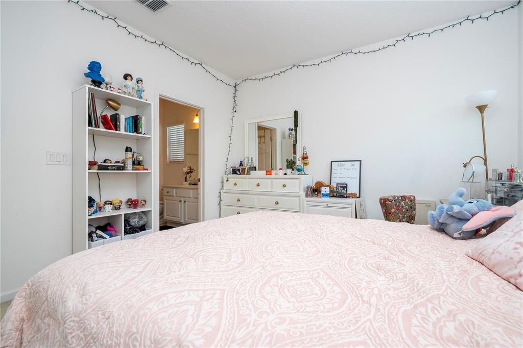 4561 Cabello Loop Kissimmee, FL 34746 - Photo 79 of 100 a bedroom with a large bed and a cabinets