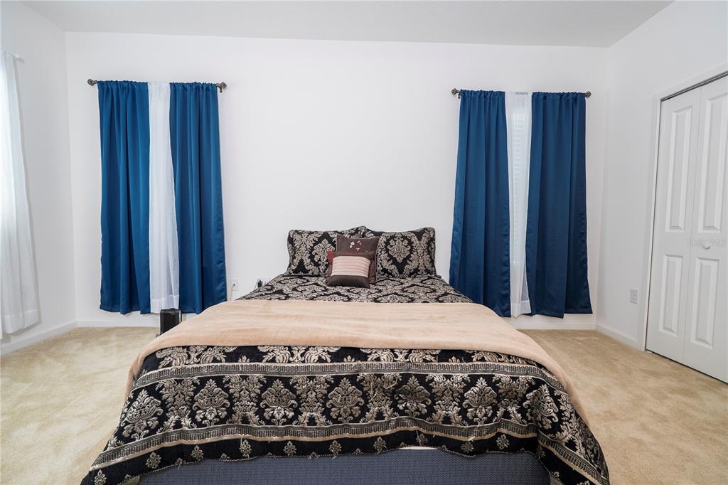 4561 Cabello Loop Kissimmee, FL 34746 - Photo 83 of 100 a bedroom with a bed and a window