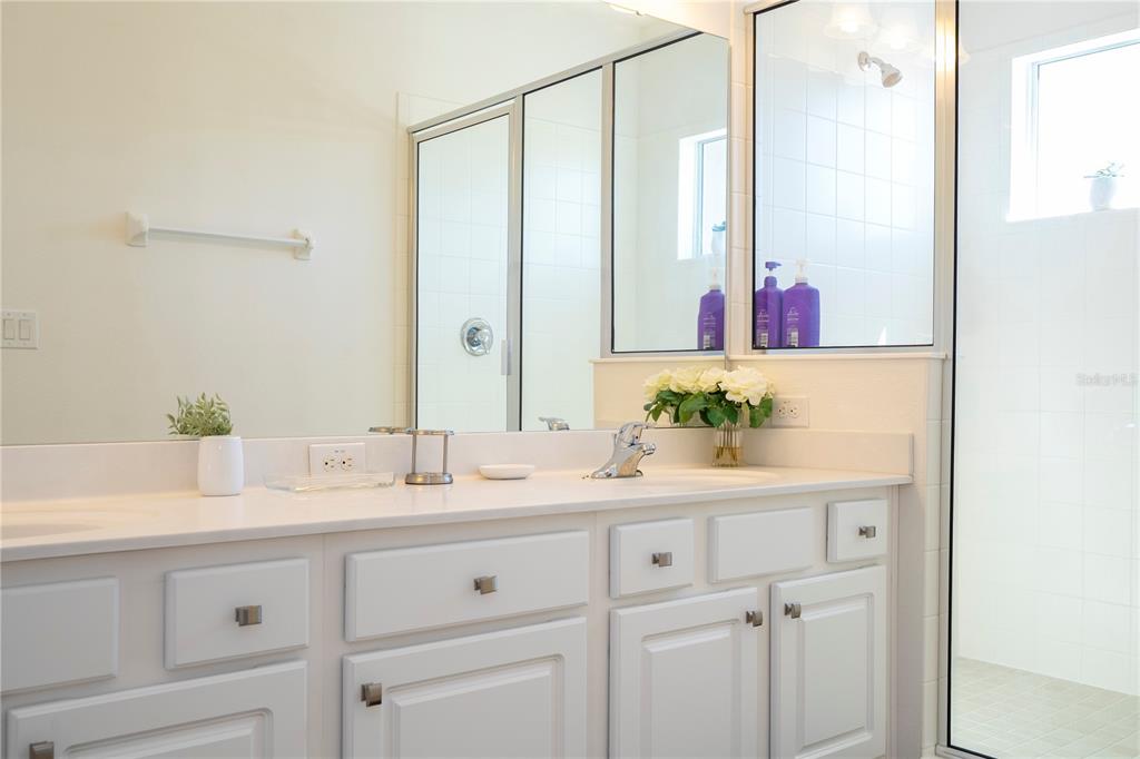 4561 Cabello Loop Kissimmee, FL 34746 - Photo 87 of 100 a bathroom with a granite countertop sink and a mirror