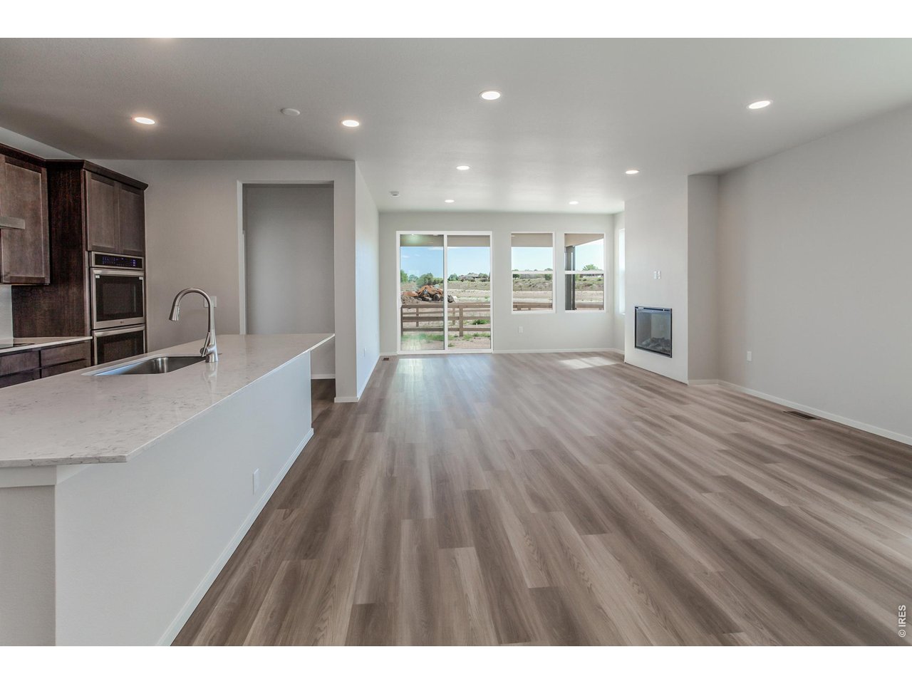 792 Chatter Road Windsor, CO 80550 - Photo 49 of 49 a view of an empty room with wooden floor and a window